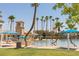 Serene beach with palm trees and blue umbrellas offers a relaxing oasis, and community amenities for residents at 3151 Soaring Gulls Dr # 2081, Las Vegas, NV 89128