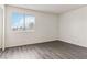 This bedroom is bright with gray, wood-look floors and a large window at 3151 Soaring Gulls Dr # 2081, Las Vegas, NV 89128
