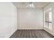 This bedroom features a ceiling fan, wood flooring, and a window allowing for plenty of natural light at 3151 Soaring Gulls Dr # 2081, Las Vegas, NV 89128