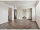 A sunny bedroom features modern gray wood-look floors and a large closet with mirror doors at 3151 Soaring Gulls Dr # 2081, Las Vegas, NV 89128
