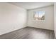 This bedroom features a window, wood flooring, and plenty of space for storage at 3151 Soaring Gulls Dr # 2081, Las Vegas, NV 89128