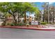 Community entrance with lush landscaping and Desert Shores Villas signage for a welcoming appeal at 3151 Soaring Gulls Dr # 2081, Las Vegas, NV 89128