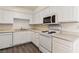 This is a close up of the kitchen featuring a dishwasher, sink, microwave, oven and range at 3151 Soaring Gulls Dr # 2081, Las Vegas, NV 89128