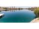 Picturesque waterfront view of a pristine lake showcasing clear water reflecting the sky, landscaping, and waterfront homes at 3151 Soaring Gulls Dr # 2081, Las Vegas, NV 89128