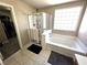 Bathroom with a separate tub and shower, tile floors and a walk-in closet nearby at 32 Focal Point Ave, North Las Vegas, NV 89031