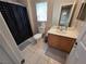 Bathroom with vanity, toilet, shower-tub combo and tile flooring at 32 Focal Point Ave, North Las Vegas, NV 89031