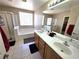 Bright bathroom featuring double sinks, a soaking tub, and a separate glass-enclosed shower at 32 Focal Point Ave, North Las Vegas, NV 89031