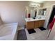 Bathroom with double sink vanity, bathtub, and tile flooring at 32 Focal Point Ave, North Las Vegas, NV 89031