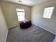Bedroom featuring two windows, carpeted floor, and a bean bag chair at 32 Focal Point Ave, North Las Vegas, NV 89031