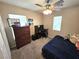 Carpeted bedroom with ceiling fan, natural light, and large closet at 32 Focal Point Ave, North Las Vegas, NV 89031
