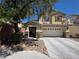 Charming two-story home with a well-maintained front yard and attached two car garage at 32 Focal Point Ave, North Las Vegas, NV 89031