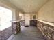 Cozy covered porch with stone accents providing shade and curb appeal to the entrance at 32 Focal Point Ave, North Las Vegas, NV 89031