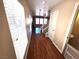 Inviting hallway with hardwood floors, large windows, and views into the living areas at 32 Focal Point Ave, North Las Vegas, NV 89031