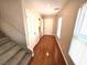 Bright hallway with hardwood floors, leading to various rooms and staircase at 32 Focal Point Ave, North Las Vegas, NV 89031