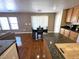 Open-concept kitchen and dining area with granite countertops and wood flooring offer a contemporary feel at 32 Focal Point Ave, North Las Vegas, NV 89031