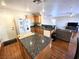 Kitchen with granite countertop island, hardwood floors, and easy access to the living area at 32 Focal Point Ave, North Las Vegas, NV 89031