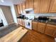 Well-equipped kitchen with wooden cabinets, laminate countertops, and white appliances offers convenience and style at 32 Focal Point Ave, North Las Vegas, NV 89031