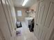 Laundry room with washer, dryer, shelving, and tile flooring at 32 Focal Point Ave, North Las Vegas, NV 89031