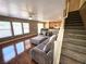 Open-concept living room with hardwood floors connecting to the kitchen and dining area at 32 Focal Point Ave, North Las Vegas, NV 89031