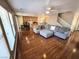 Open-concept living room and kitchen with hardwood floors creating a warm and inviting atmosphere at 32 Focal Point Ave, North Las Vegas, NV 89031