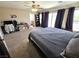 Spacious main bedroom with carpet and a ceiling fan, boasting ample space for relaxation and personalization at 32 Focal Point Ave, North Las Vegas, NV 89031