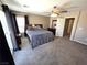 Cozy main bedroom with carpet, featuring a ceiling fan and sliding glass door to a balcony, offering a retreat-like space at 32 Focal Point Ave, North Las Vegas, NV 89031