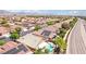 Aerial perspective showing a street with tidy landscaping and beautiful backyard pools at 3913 Ricebird Way, North Las Vegas, NV 89084