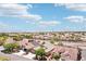Expansive aerial view of a neighborhood showcasing a street lined with well-maintained homes and lush landscaping at 3913 Ricebird Way, North Las Vegas, NV 89084