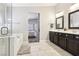 Bathroom features a shower, an oval tub and leads into the bedroom at 3913 Ricebird Way, North Las Vegas, NV 89084