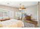 Bright bedroom features a wooden fan, a gray rug and a wooden dresser with a TV at 3913 Ricebird Way, North Las Vegas, NV 89084