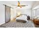 Bright bedroom features a wooden fan, a gray rug and a wooden barn door at 3913 Ricebird Way, North Las Vegas, NV 89084