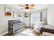 Charming Bedroom with a crib, a plush chair, and nature-inspired decor for a soothing atmosphere at 3913 Ricebird Way, North Las Vegas, NV 89084