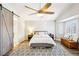 Bright bedroom features a wooden fan, a gray rug and a gray bed frame at 3913 Ricebird Way, North Las Vegas, NV 89084