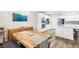 Bright dining area with wooden table, modern lighting, and easy access to the kitchen and island at 3913 Ricebird Way, North Las Vegas, NV 89084