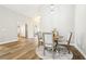 Bright dining area with a round table, seating for four, hardwood floors, and an open concept layout at 3913 Ricebird Way, North Las Vegas, NV 89084