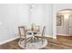 Cozy dining area with hardwood floors, a round table, seating for four, and natural light at 3913 Ricebird Way, North Las Vegas, NV 89084