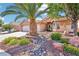 Attractive single-story home with desert landscaping, a palm tree, and a spacious two-car garage at 3913 Ricebird Way, North Las Vegas, NV 89084