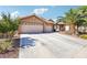 Inviting single-story home featuring a two-car garage, desert landscaping, and a private driveway at 3913 Ricebird Way, North Las Vegas, NV 89084