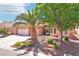 Attractive home featuring a three-car garage, desert landscaping, and a charming front garden at 3913 Ricebird Way, North Las Vegas, NV 89084