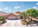 Well-maintained home showcasing a three-car garage, desert landscaping, and a neatly paved driveway at 3913 Ricebird Way, North Las Vegas, NV 89084