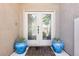 Elegant double front doors with glass inserts, framed by decorative blue planters, creates a welcoming entrance at 3913 Ricebird Way, North Las Vegas, NV 89084
