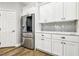 Kitchen features stainless steel appliances, white cabinets, and a stainless steel refrigerator at 3913 Ricebird Way, North Las Vegas, NV 89084