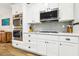 The kitchen features stainless steel appliances, white cabinets, and quartz countertops at 3913 Ricebird Way, North Las Vegas, NV 89084