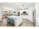 A kitchen features stainless steel appliances, white cabinets, a large island with a sink and quartz countertop, and stools at 3913 Ricebird Way, North Las Vegas, NV 89084