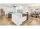 Kitchen island with stainless steel sink and dishwasher, white cabinets, and quartz countertop at 3913 Ricebird Way, North Las Vegas, NV 89084