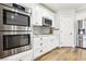 Kitchen features stainless steel appliances, white cabinets, and quartz countertops at 3913 Ricebird Way, North Las Vegas, NV 89084