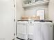 Functional laundry room with a modern washer and dryer, storage shelves, and a clean design at 3913 Ricebird Way, North Las Vegas, NV 89084
