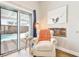 Comfortable living space with plush armchair, a built-in fireplace, and sliding doors leading to the pool area at 3913 Ricebird Way, North Las Vegas, NV 89084