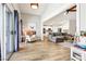 Open-concept living area featuring wood floors, a modern fireplace, and seamless access to the kitchen at 3913 Ricebird Way, North Las Vegas, NV 89084