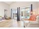 Bright living area featuring hardwood floors, access to a pool, and an adjacent sitting area with natural light at 3913 Ricebird Way, North Las Vegas, NV 89084